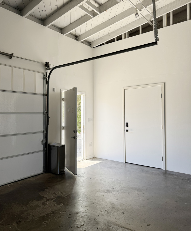 Studio entry with roll-up access and tall ceiling